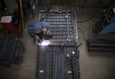 Metal construction, welder welding railing