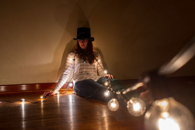 Gypsy woman sitting in illuminated lighting