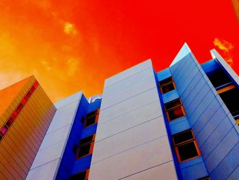 Low angle view of skyscrapers against blue sky