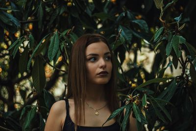 Beautiful woman amidst plants