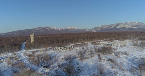 Scenic view of snowcapped mountains against clear blue sky