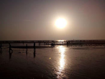 Scenic view of sea against clear sky at sunset