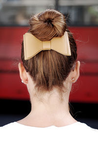 Rear view of woman with hair bun and bow