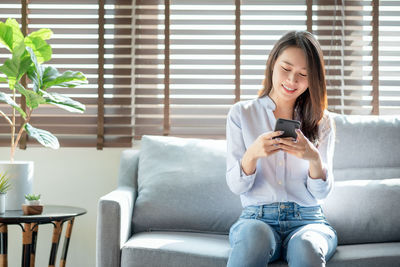 Full length of man using mobile phone