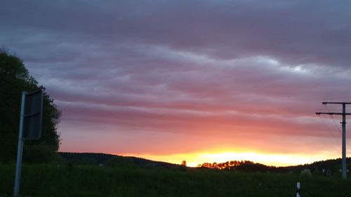 Scenic view of silhouette field against sky during sunset