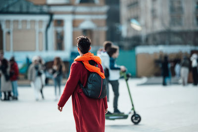 Rear view of people walking on street