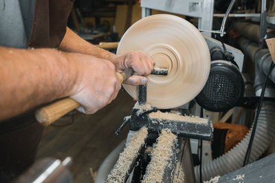 Midsection of man working in factory