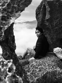 High angle view of young woman standing on rock