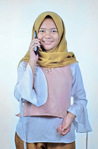 Portrait of a young student asian woman talking on mobile phone, speak happy smile