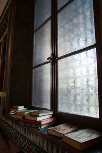 Open book on table by window