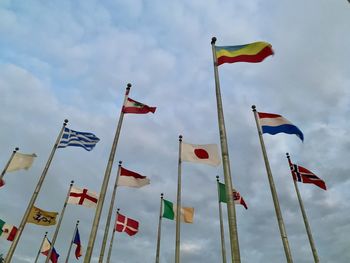 Low angle view of flag flags against sky