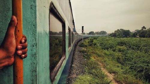 Man looking through train window