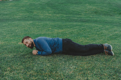 High angle view of man lying on grass