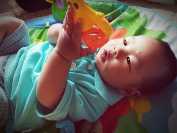 Portrait of cute baby lying on bed