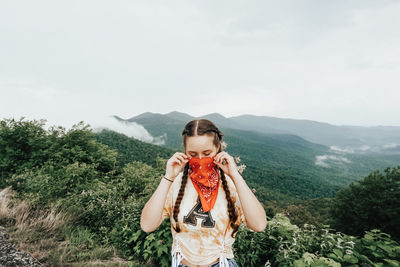 Man standing on mountain against sky