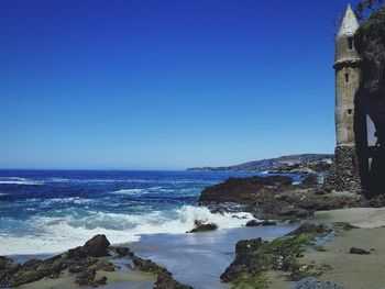 Scenic view of sea against clear blue sky