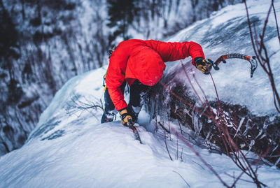 Man ice climbing on cathedral ledge in north conway, new hampshire