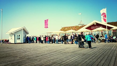 People against clear blue sky