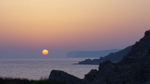 Scenic view of sea against clear sky during sunset