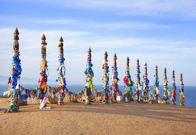 Multi colored umbrellas on land against sky