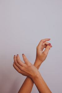 Close-up of woman hand over white background