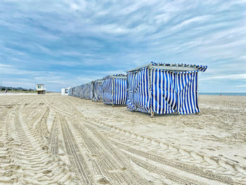 Lifeguard hut on beach against sky