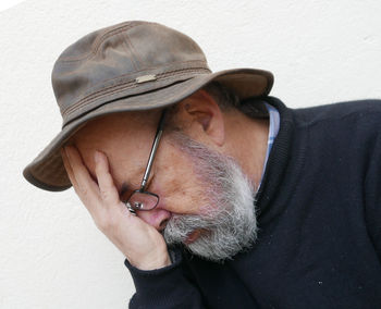 Close-up of tensed man against wall