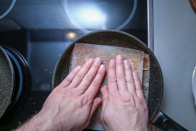 High angle view of person hand on metal