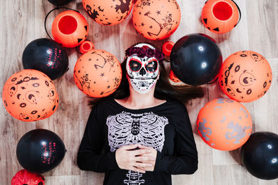 Woman wearing mask lying on floor