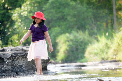 Full length of woman standing in water