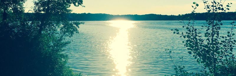 Scenic view of calm lake at sunset