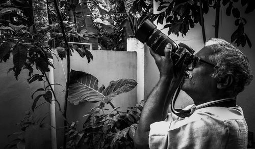 Rear view of man holding plant