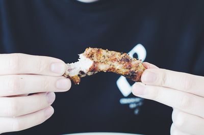 Close-up of man eating meat