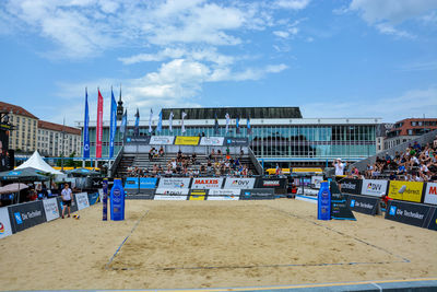 People on beach against buildings in city