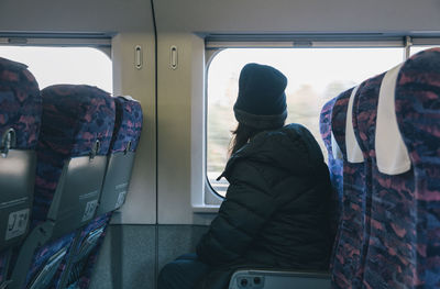 Rear view of people in train