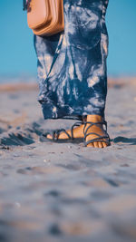 Low section of woman standing on beach