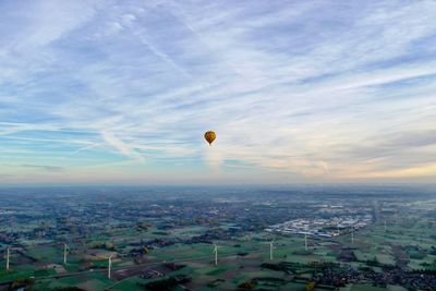 Hot air balloons flying over buildings in city