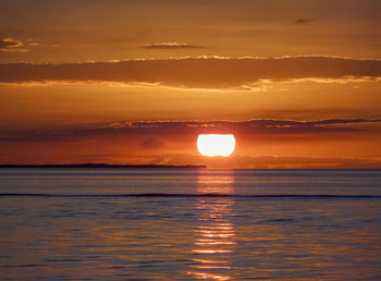 Scenic view of sea against romantic sky at sunset