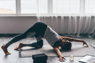 Low section of woman exercising in gym