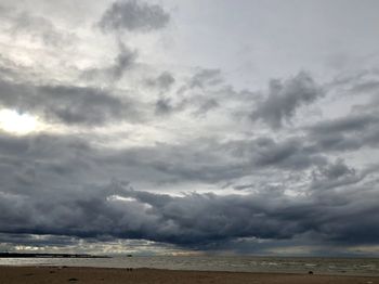 Scenic view of sea against storm clouds