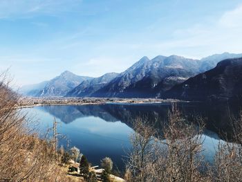 Scenic view of lake and mountains against sky