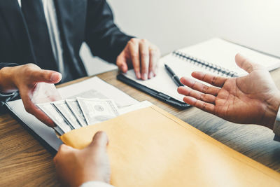 High angle view of man holding hands on table