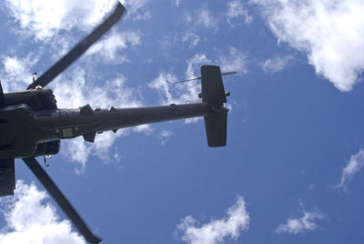 Low angle view of windmill against cloudy sky