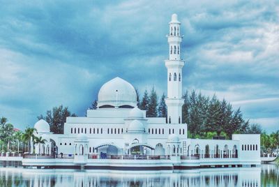 View of mosque against cloudy sky