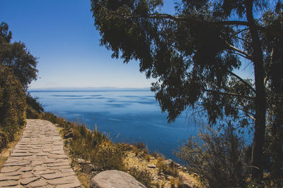 Walkway at lakeshore against sky