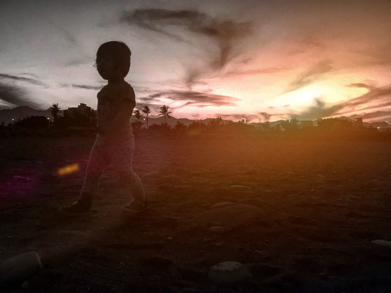 SILHOUETTE OF BOY STANDING ON LANDSCAPE AGAINST SKY