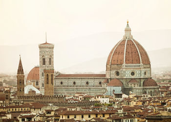 Golden sunset of palazzo vecchio and cathedral of santa maria del fiore, florence, italy.