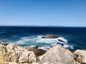 Scenic view of sea against clear blue sky