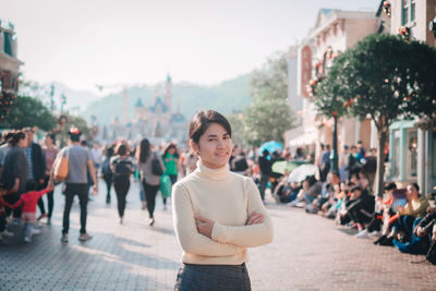 Portrait of woman standing in city