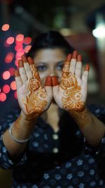 Close-up of hand holding illuminated lighting equipment